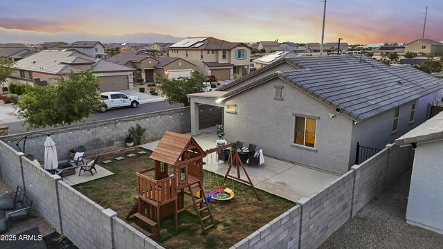 back of house featuring a residential view, a fenced backyard, and a patio area