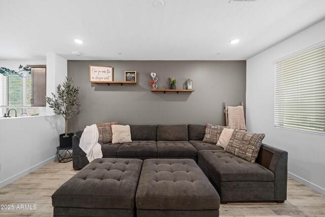 living room featuring recessed lighting, light wood finished floors, baseboards, and visible vents
