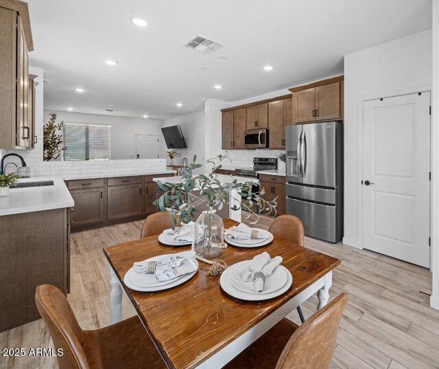 dining room featuring visible vents, recessed lighting, and light wood-style floors