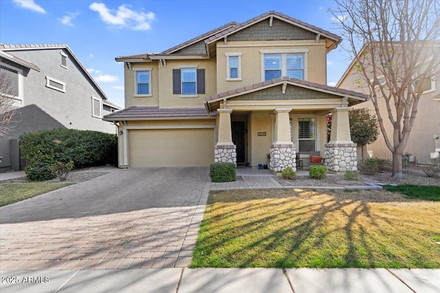 craftsman-style house with a tiled roof, decorative driveway, a garage, and stucco siding