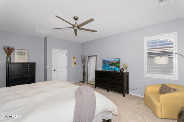 bedroom with a ceiling fan, visible vents, and light carpet