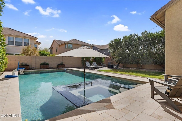 view of swimming pool featuring a patio area, a fenced in pool, an in ground hot tub, and a fenced backyard