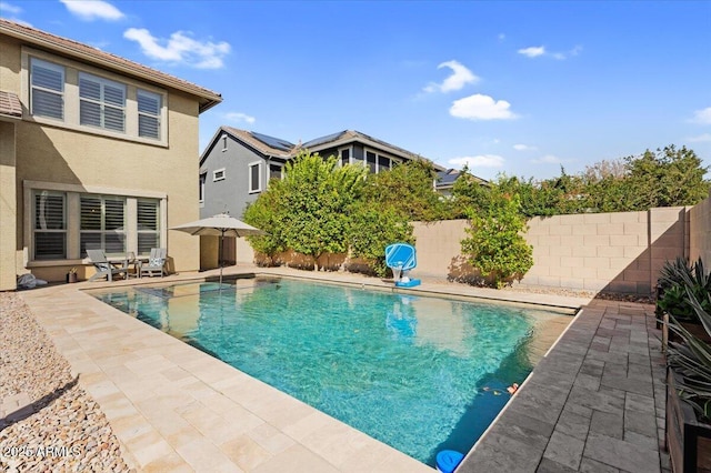 view of swimming pool featuring a patio, a fenced backyard, and a fenced in pool