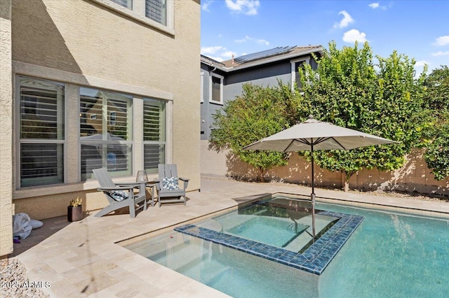 view of swimming pool with a patio and a pool with connected hot tub