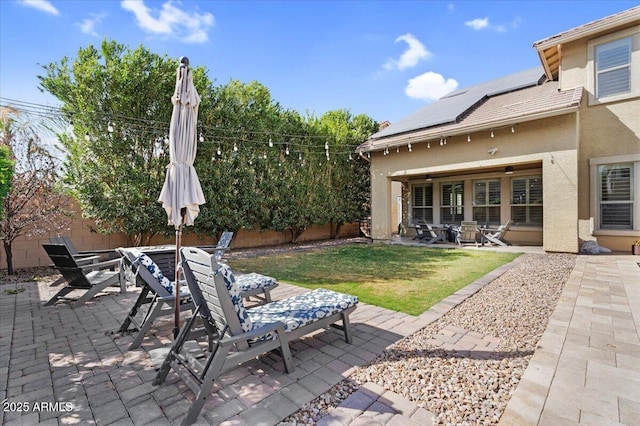 view of patio featuring outdoor dining area and fence