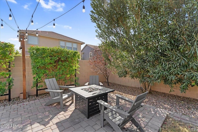 view of patio / terrace featuring an outdoor fire pit and a fenced backyard