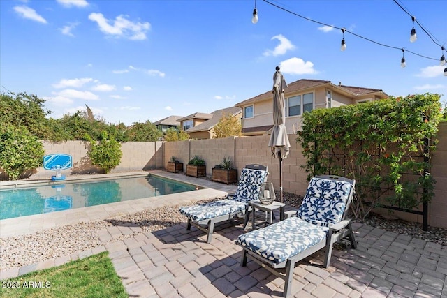 view of swimming pool featuring a fenced in pool, a patio, and a fenced backyard