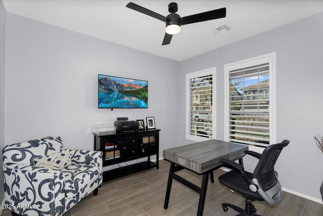 office with visible vents, baseboards, ceiling fan, and wood tiled floor