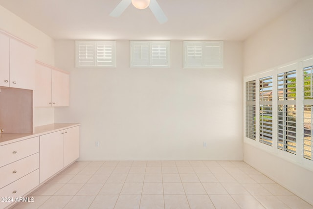 spare room featuring ceiling fan and light tile patterned floors