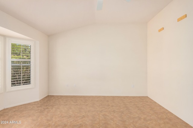 spare room with lofted ceiling