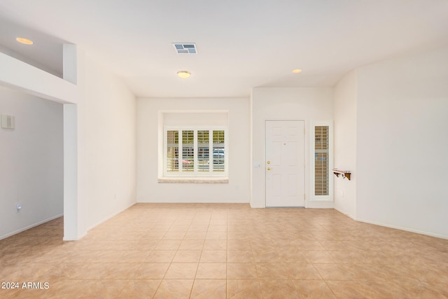 unfurnished room with light tile patterned floors