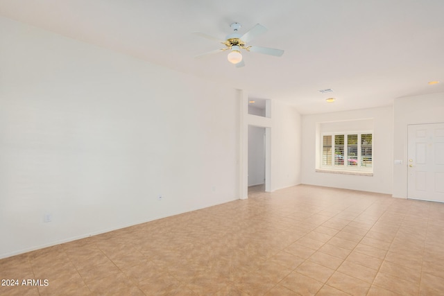 empty room with light tile patterned flooring and ceiling fan