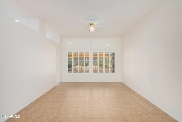 tiled empty room with ceiling fan