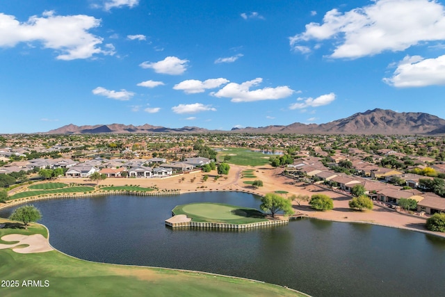 drone / aerial view featuring a water and mountain view, view of golf course, and a residential view