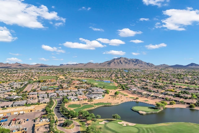 drone / aerial view featuring view of golf course, a residential view, and a water and mountain view