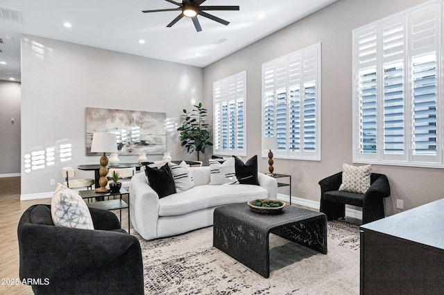 living area featuring visible vents, wood finished floors, baseboards, recessed lighting, and a ceiling fan