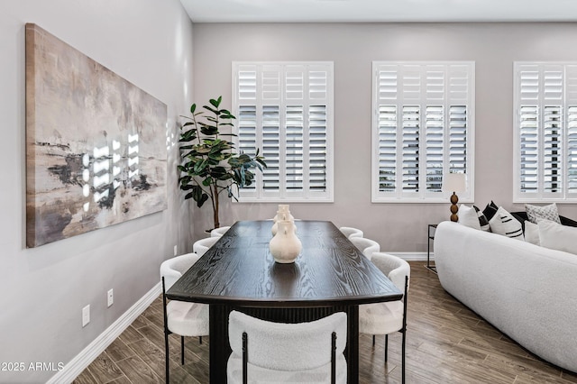 dining area featuring baseboards and wood finished floors