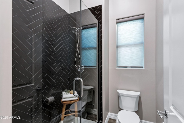 bathroom featuring a stall shower and toilet