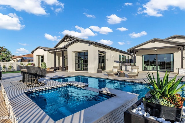 view of swimming pool with a fenced in pool, fence, an in ground hot tub, and a patio area