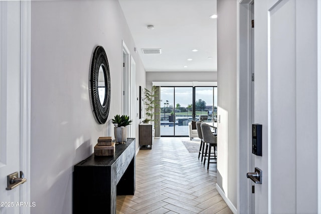 hallway with recessed lighting, baseboards, and visible vents