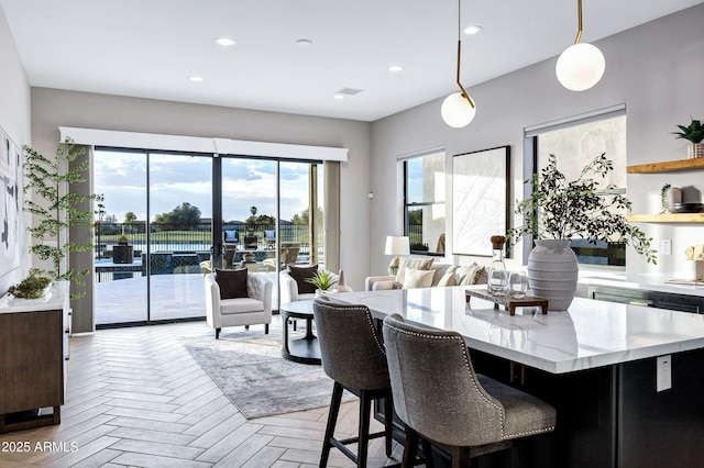 dining area with a healthy amount of sunlight, recessed lighting, and visible vents