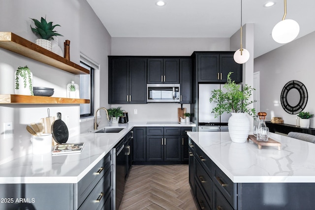 kitchen with a center island, hanging light fixtures, open shelves, a sink, and stainless steel microwave