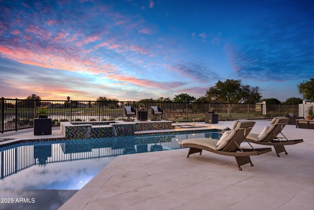view of swimming pool featuring fence, an in ground hot tub, a fenced in pool, and a patio area