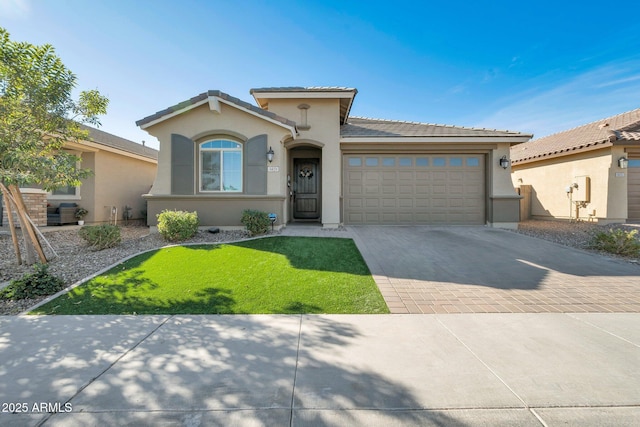 mediterranean / spanish-style house with a garage and a front lawn