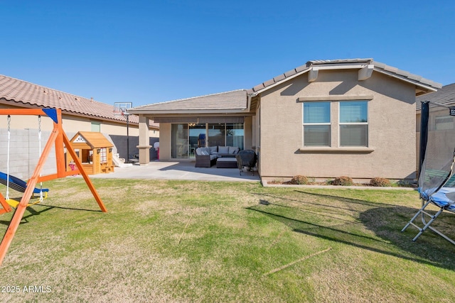 back of house with a yard, an outdoor living space, a trampoline, a playground, and a patio area