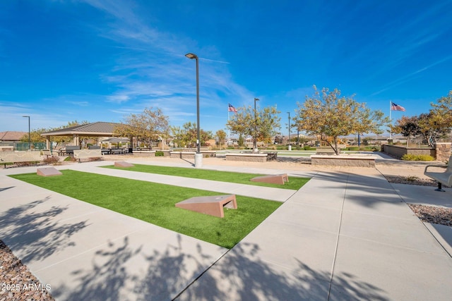 view of property's community with a gazebo and a lawn