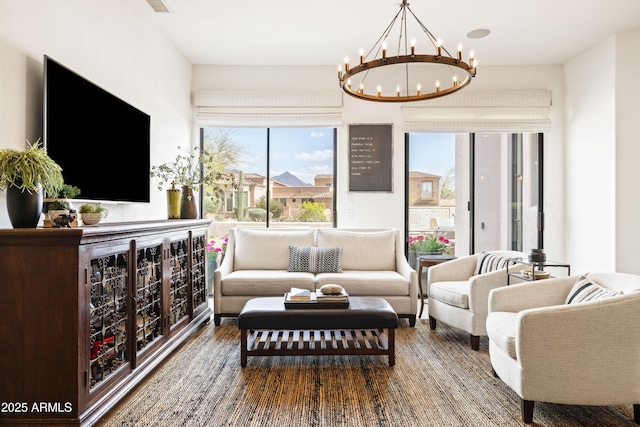 living room with a chandelier and wood finished floors