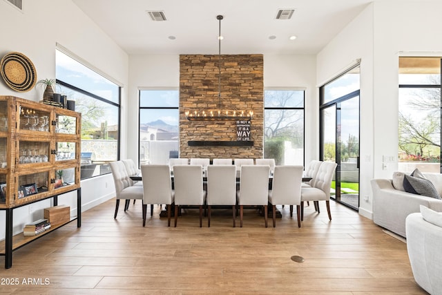 dining space featuring visible vents and light wood-style flooring