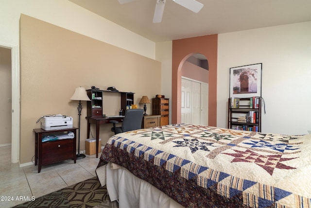 bedroom with light tile patterned floors, a closet, and ceiling fan