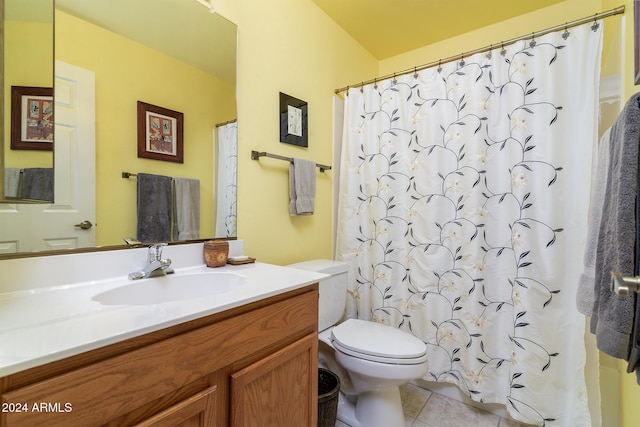 bathroom featuring tile patterned flooring, vanity, toilet, and walk in shower