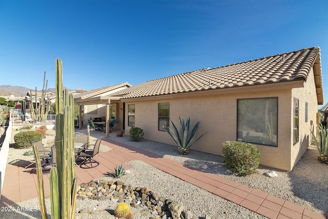 rear view of property featuring a patio