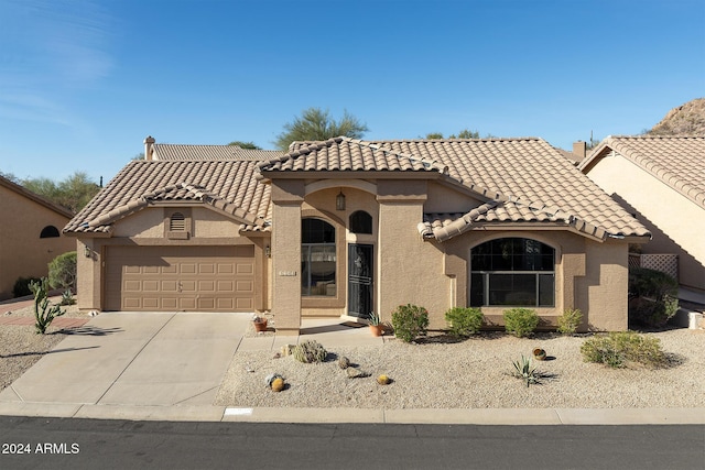 mediterranean / spanish-style house featuring a garage