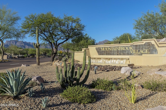 community sign with a mountain view