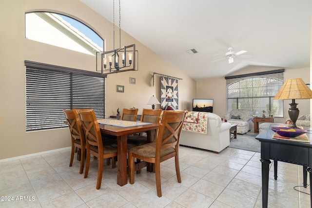 dining area featuring light tile patterned floors, ceiling fan with notable chandelier, vaulted ceiling, and a healthy amount of sunlight