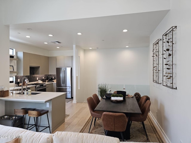 dining area with recessed lighting, visible vents, baseboards, and light wood-style flooring