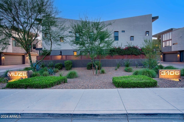 exterior space with a garage and stucco siding