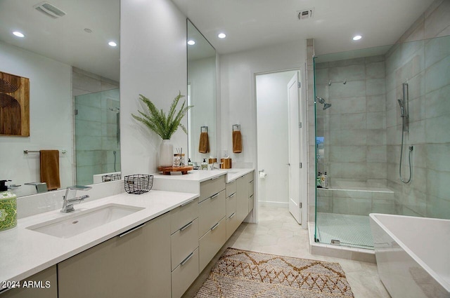 bathroom featuring vanity, tile patterned floors, and shower with separate bathtub