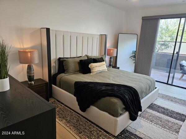 bedroom featuring light hardwood / wood-style floors and access to exterior