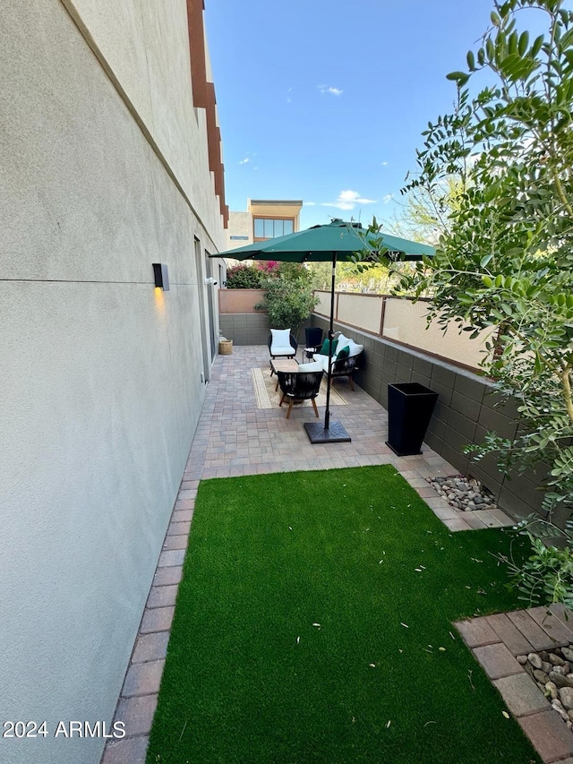 view of yard with a patio, fence, and an outdoor hangout area