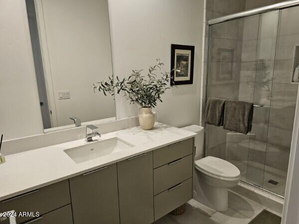 bathroom with vanity, toilet, and walk in shower