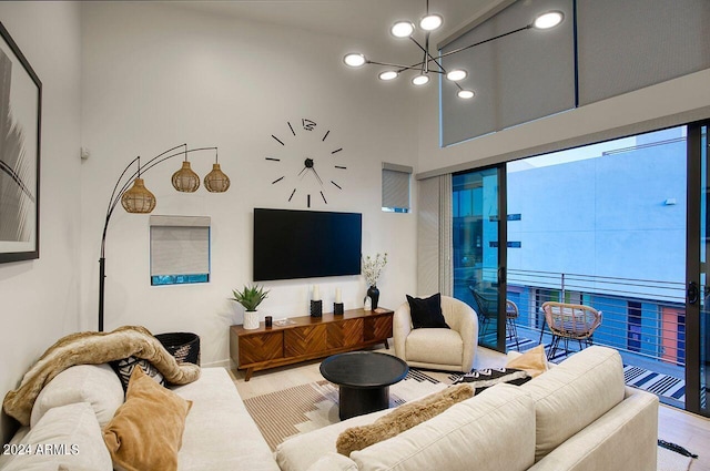 living room with high vaulted ceiling and a chandelier