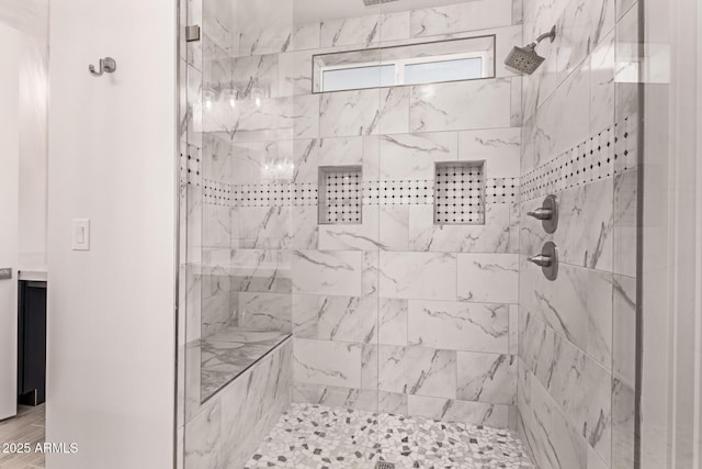 bathroom with tiled shower