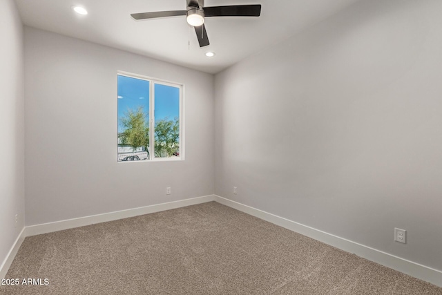 carpeted spare room with ceiling fan