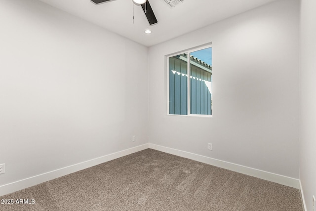 spare room with carpet floors and ceiling fan