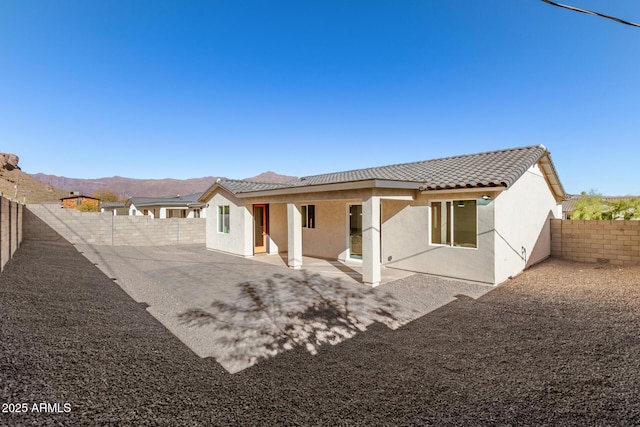 back of house featuring a patio area and a mountain view