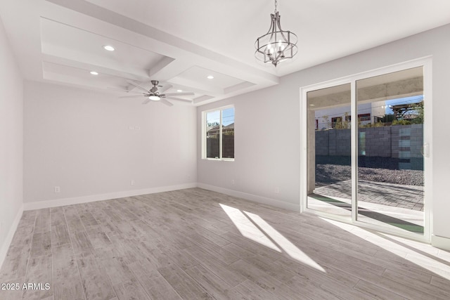 spare room featuring ceiling fan with notable chandelier, light wood-type flooring, coffered ceiling, and beamed ceiling